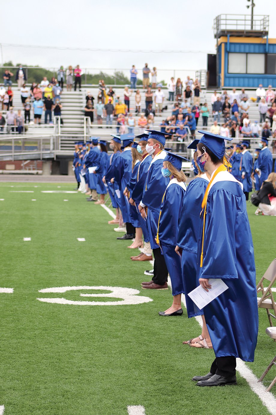 Spaced for social distancing, the front row of Crawfordsville graduates eagerly await their diplomas.
